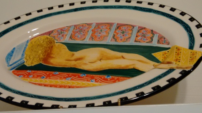 painting of nude reclining woman on ceramic platter
