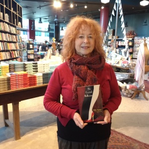 Libby Sommer holding a copy of The Crystal Ballroom in book store